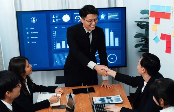 Businesspeople shake hand after successful agreement or meeting. Office worker colleague handshake with business team leader manager for strong teamwork in office to promote harmony and unity concept.