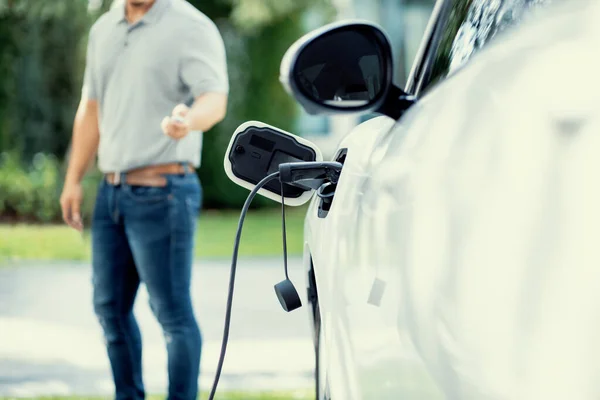 Focus Recharging Electric Vehicle Outdoor Charging Station Blurred Background Man — Stock Fotó