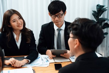 Business team of financial data analysis meeting with business intelligence, report paper and dashboard on laptop for marketing strategy. Business people working together to promote harmony in office.