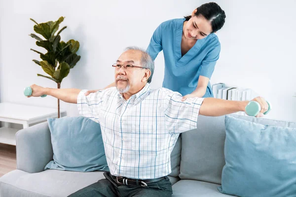 Contented Senior Patient Doing Physical Therapy Help His Caregiver Senior — Stockfoto
