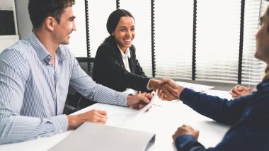 Commercial contract signed by competent people of various ethnicities and shake hands. Trade agreements, two-party business transactions.