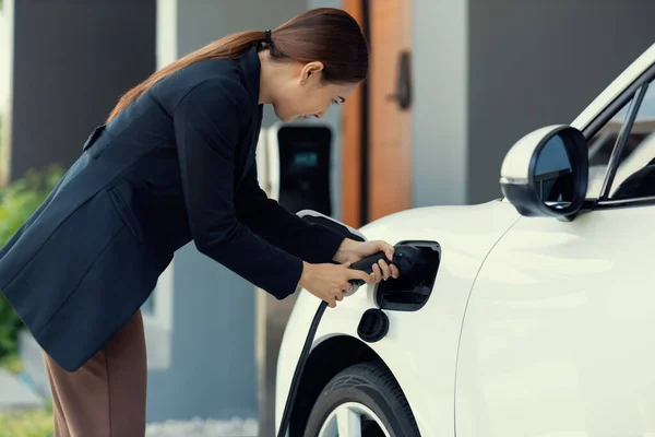 Progressive Woman Install Cable Plug Her Electric Car Home Charging — Stok fotoğraf