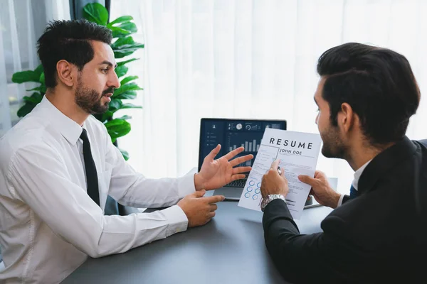 stock image Interviewing job applicant in office with resume paper. Candidate wear suit for formal conversation with interviewer. Recruitment process with question about career and work experience. Fervent