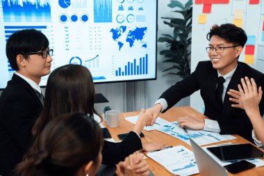 Businesspeople shake hand after successful agreement or meeting. Office worker colleague handshake with business team leader manager for strong teamwork in office to promote harmony and unity concept.