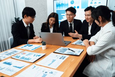 Business team of financial data analysis meeting with business intelligence, report paper and dashboard on laptop for marketing strategy. Business people working together to promote harmony in office.