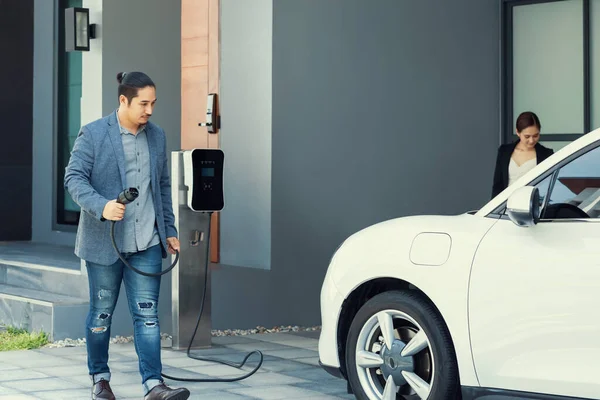 Concept Progressive Young Couple Home Charging Station Electric Vehicle Encouraging — Stock fotografie
