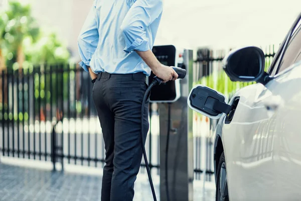 Closeup Progressive Man Holding Charger Plug Public Charging Station Electric — Stok fotoğraf