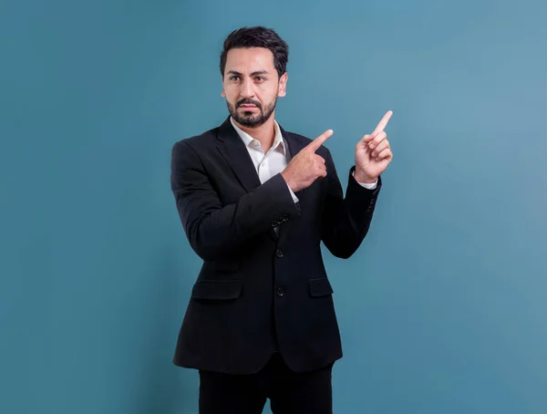 stock image Confident businessman in formal suit pointing finger up to indicate promotion or advertising with excited and amazed facial expression and gesture on isolated background. Fervent