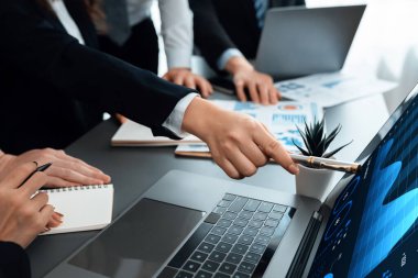 Business team analyze business analytic or business intelligence dashboard on laptop screen show graph and chart with statistic in harmony office. Analyst team meeting researching, planning strategy.