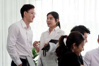 Mentor, manager advice younger colleagues in workplace. Businesspeople discussing or planning financial project strategy, talking together for harmony and strong teamwork in office concept.