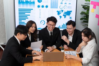 Business team of financial data analysis meeting with business intelligence, report paper and dashboard on laptop for marketing strategy. Business people working together to promote harmony in office.