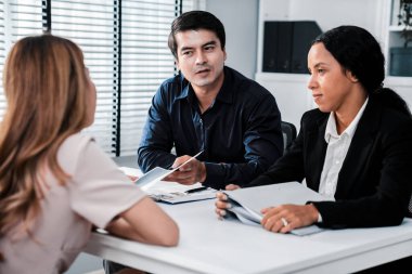 A young female asian candidate tries to impress her interviewer by being competent. International company, multicultural environment in workplace.