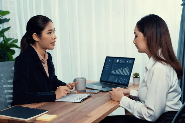 Business deal meeting, young businesswomen carefully reviewing terms and condition of contract agreement papers in office. Corporate lawyer give consultation on contract deal. Enthusiastic