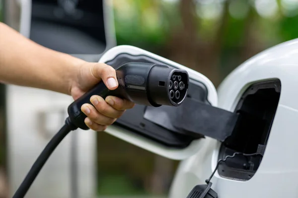 Hand Inserting Charging Plug Electric Vehicle Focus Shot Blurred Background — Foto de Stock