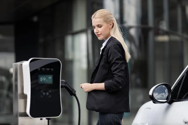 Progressive Businesswoman Insert Charger Plug Charging Station Her Electric Vehicle — Foto de Stock