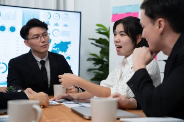 Business team of financial data analysis meeting with business intelligence, report paper and dashboard on laptop for marketing strategy. Business people working together to promote harmony in office.