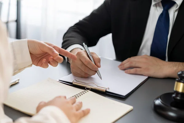 stock image Lawyer signing contract, professional lawyer in law firm office drafting legal document or contract agreement ensuring lawful protection for clients disputes as fairness advocate concept. Equilibrium