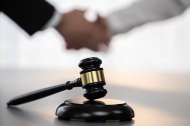 Odaklanma tokmağı avukat meslektaşlarının bulanık arkaplan üzerine adaleti sembolize eder başarılı bir hukuki anlaşmadan sonra mahkemedeki anlaşmazlığı savunmak güvenilir bir ortağın güvenilirliğini sağlar. Eşitlik