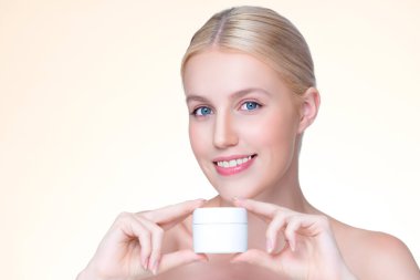 Personable beautiful perfect natural skin woman hold mockup tube moisturizer cream for skincare treatment product advertisement in isolated background with expressive facial and gesture expression.