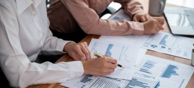 Yakın plan analist takım arkadaşları dijital torpido gözündeki finansal verileri, çizelgeleri ve grafiği destekleyici takım çalışmasıyla tartıştılar. Profesyonel ofis pazarlama işini planlamak için BI 'ı kullanır. Coşkulu.