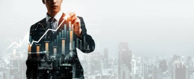 Businessman analyst working with digital finance business data graph showing technology of investment strategy for perceptive financial business decision. Digital economic analysis technology concept.