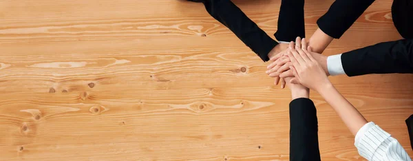 stock image Top view partial hands wearing formal suit joining stack and form circle as symbol of team building, unity and harmony in office workplace. Successful business team of synergy holding hand together.