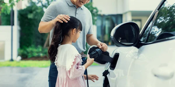 Progressive Father Daughter Returned School Electric Vehicle Being Charged Home — Foto Stock