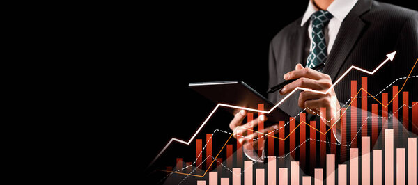 Businessman analyst working with digital finance business data graph showing technology of investment strategy for perceptive financial business decision. Digital economic analysis technology concept.