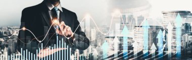 Businessman analyst working with digital finance business data graph showing technology of investment strategy for perceptive financial business decision. Digital economic analysis technology concept.