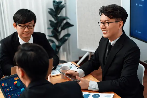 stock image Manager of financial data analysis team meeting with BI report paper and dashboard on laptop for marketing strategy. Business people working together to promote harmony in office.