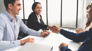 Commercial contract signed by competent people of various ethnicities and shake hands. Trade agreements, two-party business transactions.