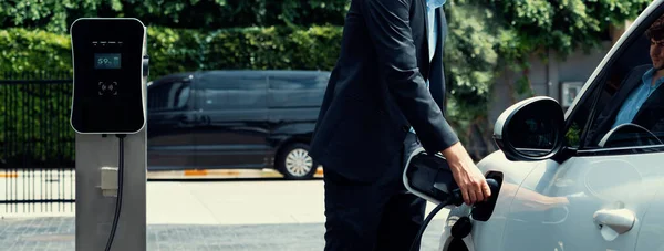 Closeup Progressive Black Suit Businessman Insert Charger Plug Public Charging — Φωτογραφία Αρχείου
