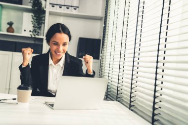 This photo depicts a young African American and competent woman at her workplace. A female employee in her office at work.