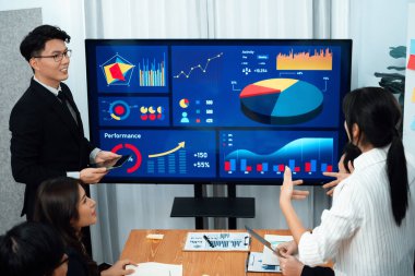 Confidence and asian businessman give presentation on financial analyzed by business intelligence in dashboard report to other people in board room meeting to promote harmony in workplace.