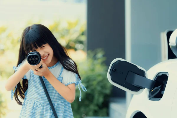 Playful Girl Holding Pointing Plug Home Charging Station Providing Sustainable — Foto Stock