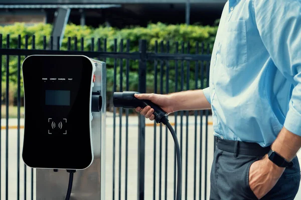 Closeup Progressive Man Holding Charger Plug Public Charging Station Electric — Φωτογραφία Αρχείου
