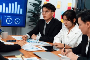 Business team of financial data analysis meeting with business intelligence, report paper and dashboard on laptop for marketing strategy. Business people working together to promote harmony in office.