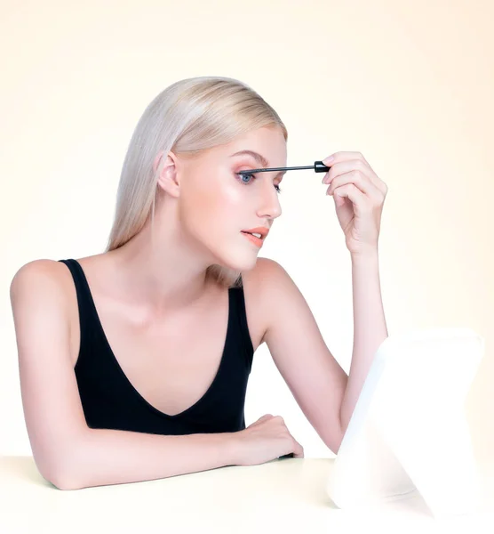 Personable Woman Blond Hair Putting Black Mascara Brush Hand Long — стоковое фото