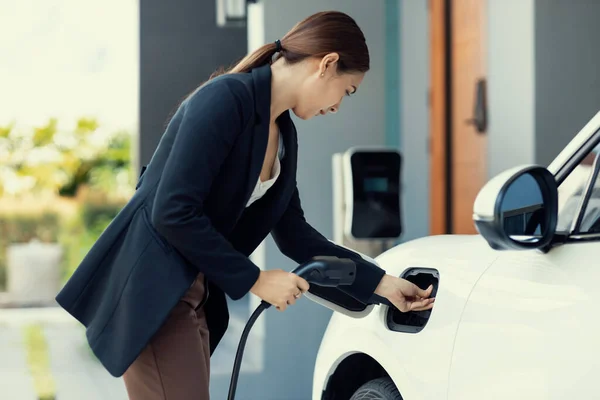 Progressive Woman Install Cable Plug Her Electric Car Home Charging — Foto de Stock