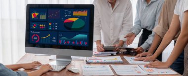 Panorama analist ekibi, FBI Fintech 'i kullanarak dizüstü bilgisayarla mali raporu analiz ediyor. İş adamları iş görüşü için dizüstü bilgisayarda gösterilen kontrol panelini inceliyor. İnceleyin