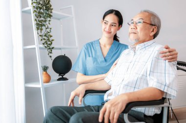 Caring nurse and a contented senior man in a wheel chair at home, nursing house. Medical for elderly patient, home care for pensioners.