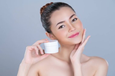 Glamorous beautiful perfect cosmetic skin with soft makeup woman portrait hold mockup jar cream or moisturizer for skincare treatment and anti-aging product advertisement in isolated background.