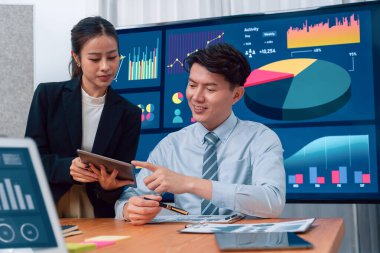 Business team of financial data analysis meeting with business intelligence, report paper and dashboard on laptop for marketing strategy. Business people working together to promote harmony in office.