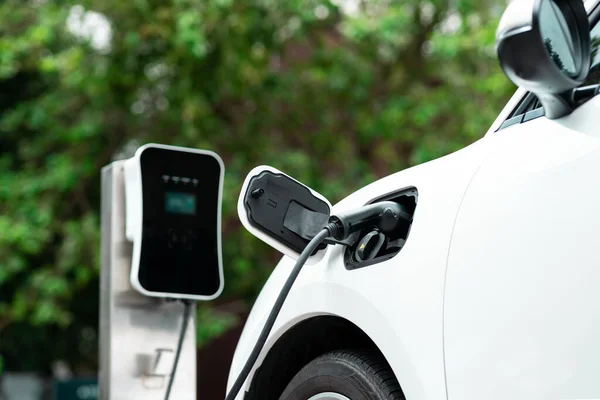 Focus Closeup Electric Vehicle Plugged Charger Device Blurred Background Public — стоковое фото