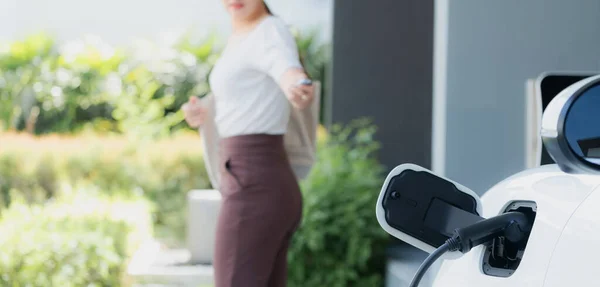 Focus Charger Plugged Car Home Charging Station Blurred Background Progressive — Φωτογραφία Αρχείου