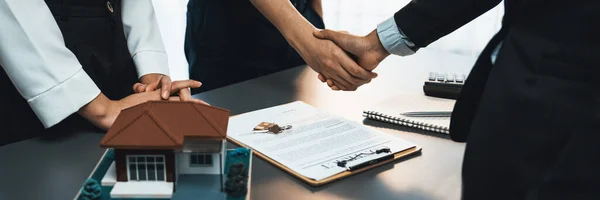 stock image Client and real estate agent shake hand after signing house loan contract. Successful agreement for new home purchase sealing deal by handshaking. Housing business and finance panorama image. Prodigy