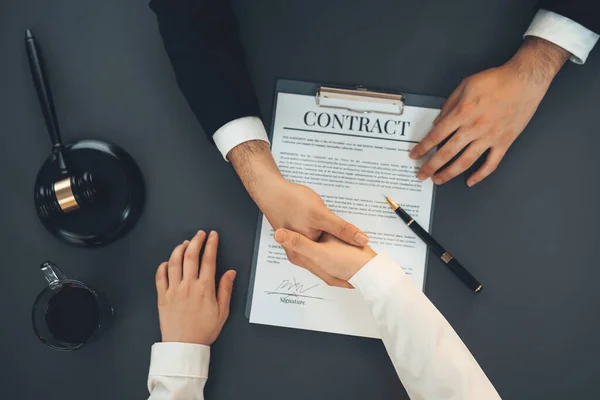 stock image Top view lawyer or attorneys colleagues handshake after successful legal discussing on contract agreement for lawsuit to advocate resolves dispute in court ensuring trustworthy partner. Equilibrium