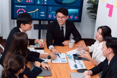 Business team of financial data analysis meeting with business intelligence, report paper and dashboard on laptop for marketing strategy. Business people working together to promote harmony in office.