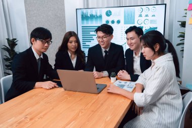 Business team of financial data analysis meeting with business intelligence, report paper and dashboard on laptop for marketing strategy. Business people working together to promote harmony in office.