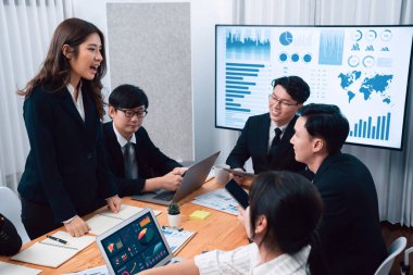 Business team of financial data analysis meeting with business intelligence, report paper and dashboard on laptop for marketing strategy. Business people working together to promote harmony in office.